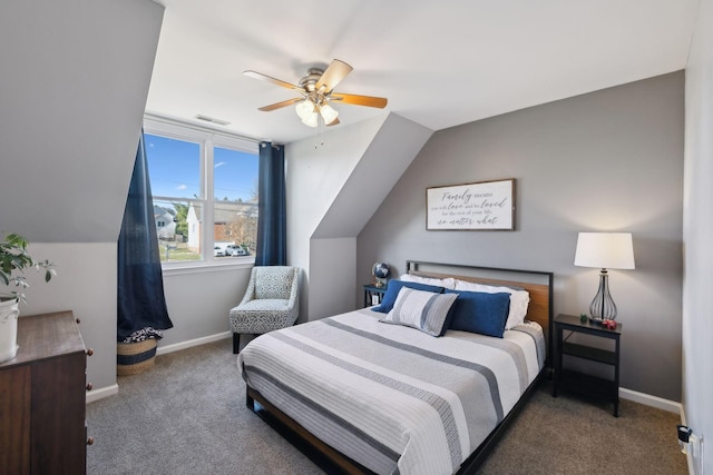 bedroom with ceiling fan, vaulted ceiling, and dark carpet