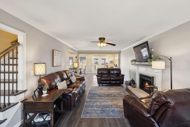 living room with ornamental molding, dark hardwood / wood-style floors, and ceiling fan