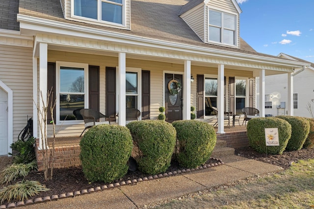 view of exterior entry featuring covered porch