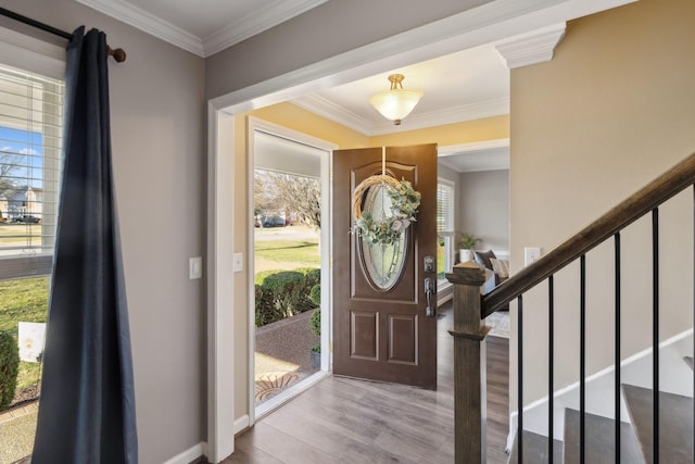 foyer entrance with crown molding and light wood-type flooring