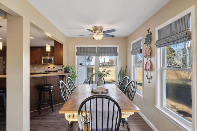 dining space featuring ceiling fan and dark hardwood / wood-style floors