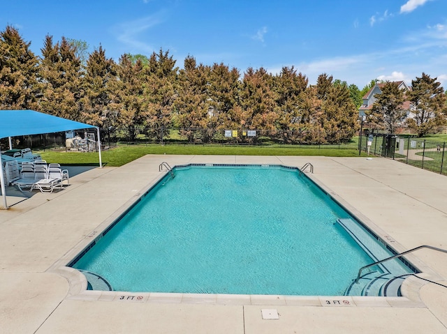 view of pool with a lawn and a patio area