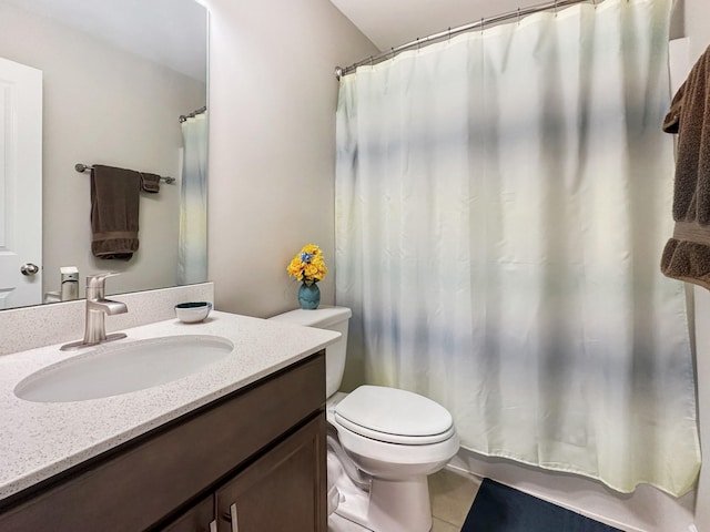 bathroom featuring vanity, tile patterned floors, and toilet