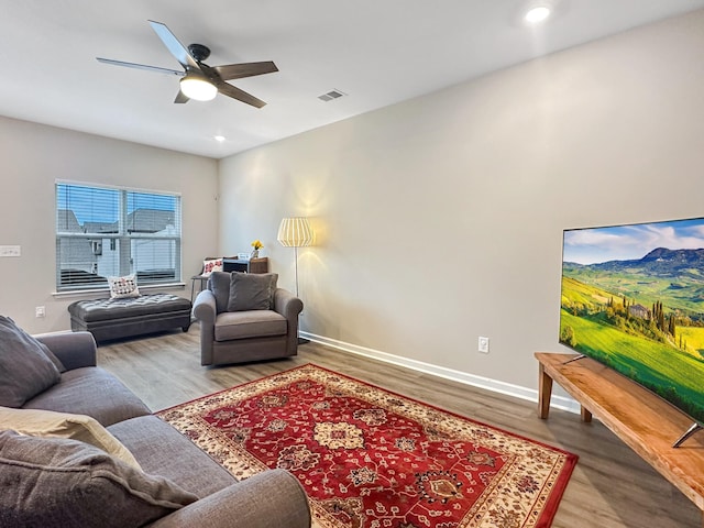 living room with hardwood / wood-style flooring and ceiling fan