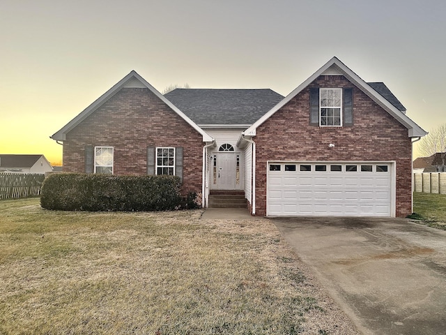 view of property featuring a garage and a yard