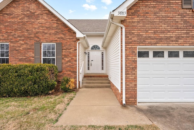 view of exterior entry with a garage