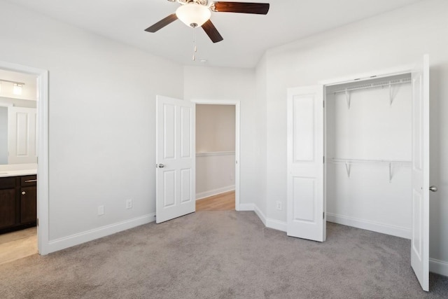 unfurnished bedroom with connected bathroom, light carpet, ceiling fan, and a closet