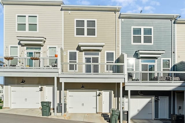 back of property featuring a garage and a balcony