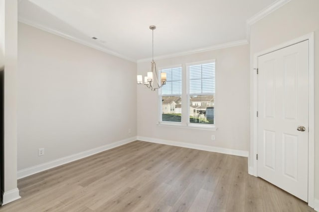 unfurnished dining area with an inviting chandelier, ornamental molding, and light wood-type flooring