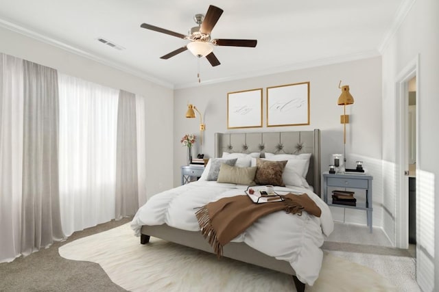 bedroom with ornamental molding, light colored carpet, and ceiling fan