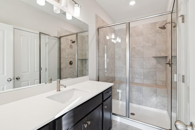 bathroom with vanity and a shower with shower door