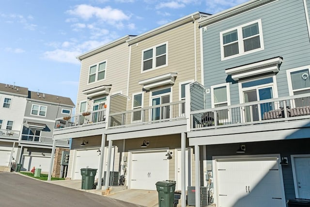 view of front of house featuring central AC and a balcony