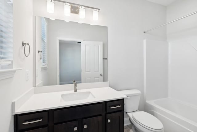 full bathroom with vanity,  shower combination, and toilet