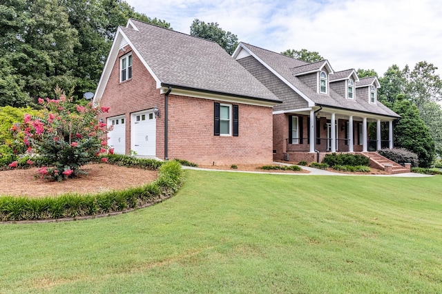 cape cod home with a garage, covered porch, and a front lawn