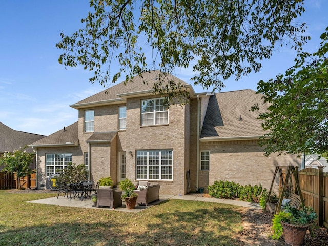 back of house featuring an outdoor living space, a patio area, and a lawn