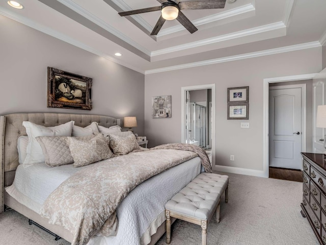 bedroom with light colored carpet, ceiling fan, a raised ceiling, crown molding, and ensuite bath