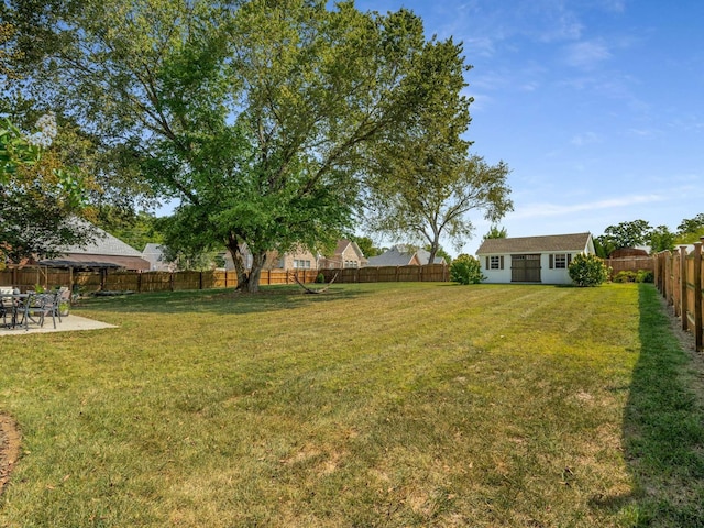 view of yard with an outdoor structure and a patio area