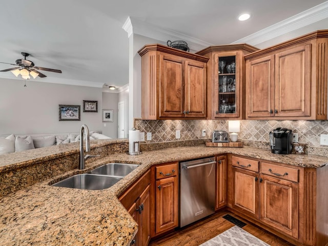 kitchen featuring sink, crown molding, stainless steel dishwasher, light stone countertops, and decorative backsplash