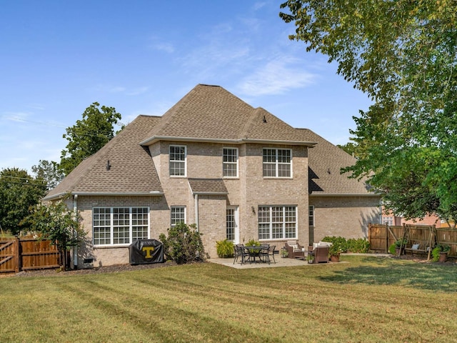 back of property featuring a lawn and a patio area