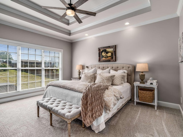 carpeted bedroom with ornamental molding, a raised ceiling, and ceiling fan