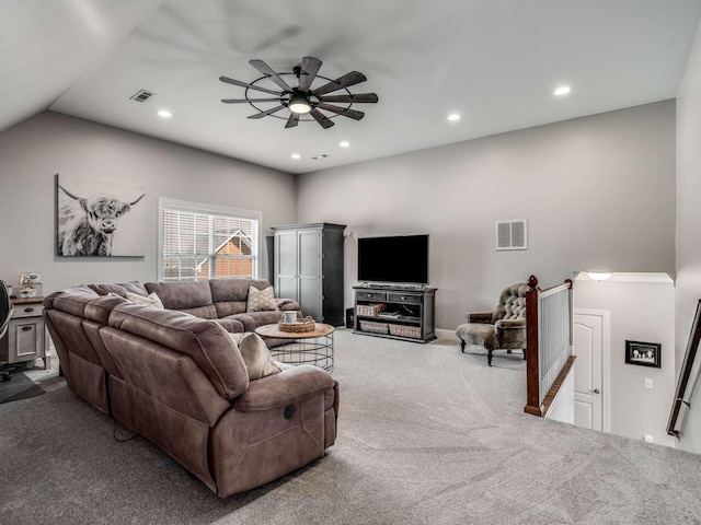 carpeted living room with lofted ceiling and ceiling fan