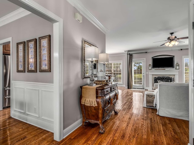 corridor featuring crown molding and hardwood / wood-style floors