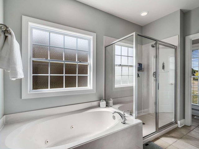 bathroom with a wealth of natural light, tile patterned floors, and shower with separate bathtub