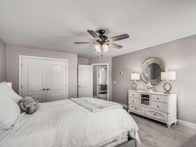 bedroom with light carpet, a closet, and ceiling fan