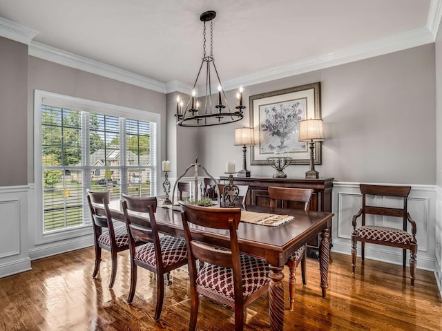 dining space with ornamental molding, dark hardwood / wood-style floors, and a notable chandelier