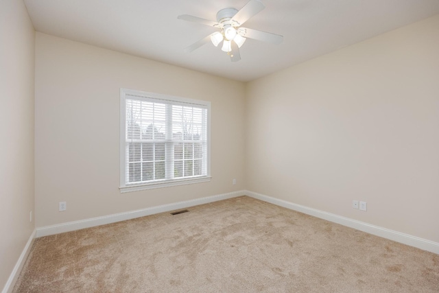 unfurnished room with light carpet and ceiling fan