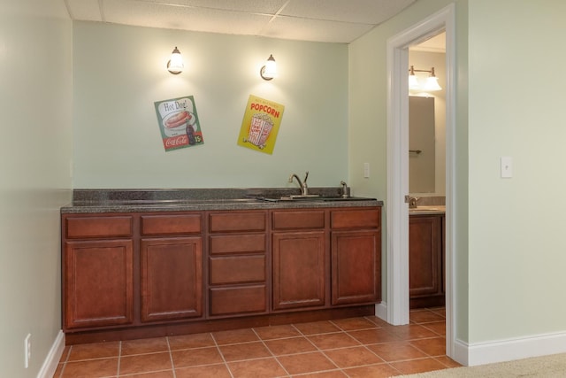 bathroom featuring a drop ceiling, vanity, and tile patterned flooring