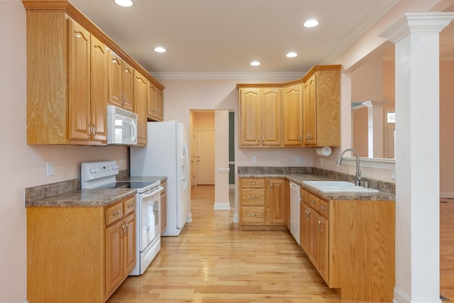 kitchen with decorative columns, sink, light hardwood / wood-style floors, crown molding, and white appliances