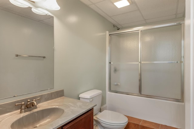 full bathroom with shower / bath combination with glass door, a paneled ceiling, vanity, and toilet