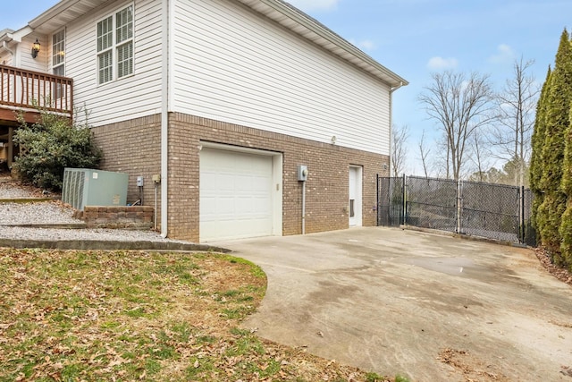 view of home's exterior featuring a wooden deck and a garage