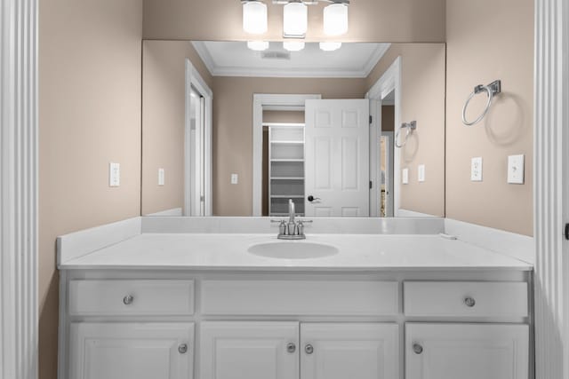 bathroom with visible vents, vanity, and crown molding