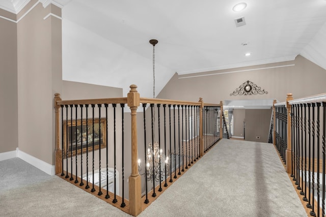 hall featuring an upstairs landing, vaulted ceiling, baseboards, and carpet floors