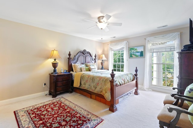 bedroom featuring visible vents, ceiling fan, baseboards, ornamental molding, and carpet flooring