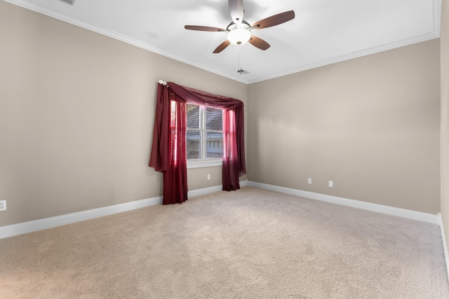 unfurnished room featuring baseboards, light carpet, ceiling fan, and crown molding