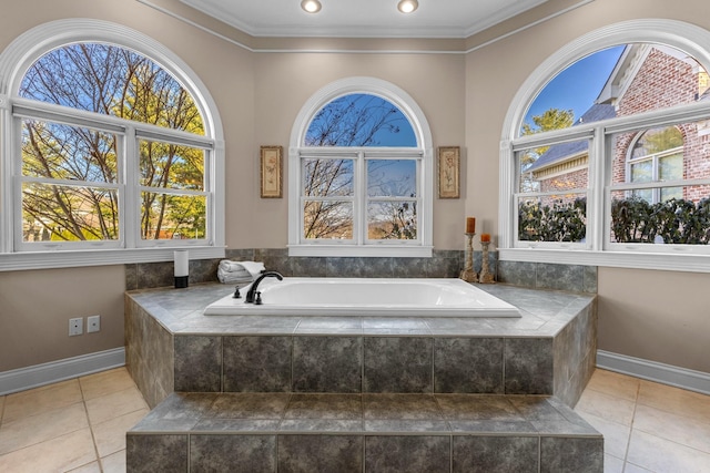 bathroom with tile patterned floors, crown molding, and a garden tub