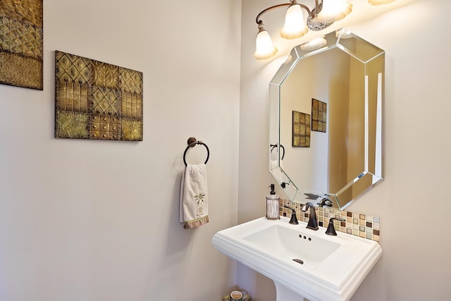 bathroom with backsplash and a sink