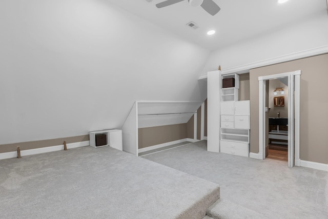 additional living space with visible vents, a ceiling fan, baseboards, carpet flooring, and lofted ceiling