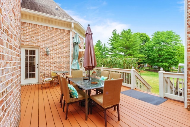 wooden deck featuring outdoor dining area