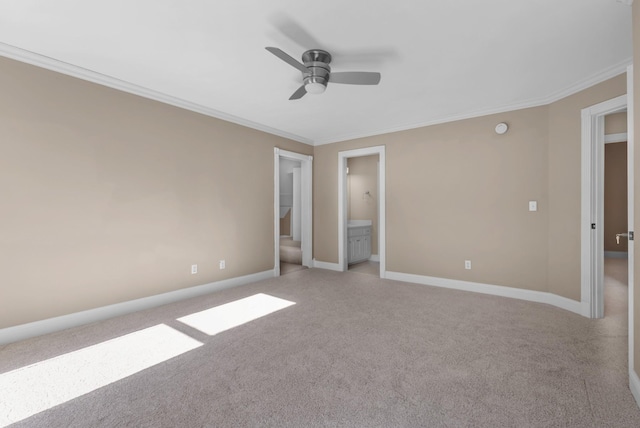 unfurnished bedroom featuring crown molding, a ceiling fan, baseboards, and light carpet