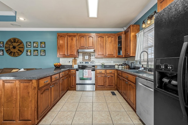 kitchen with tasteful backsplash, sink, ornamental molding, light tile patterned floors, and stainless steel appliances