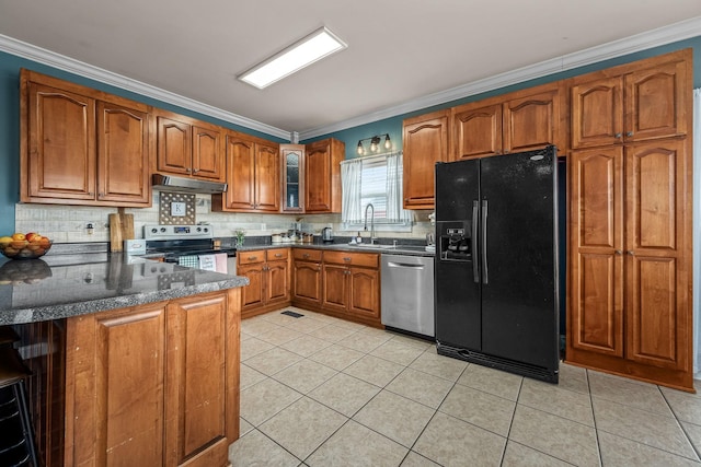 kitchen featuring crown molding, appliances with stainless steel finishes, backsplash, and kitchen peninsula