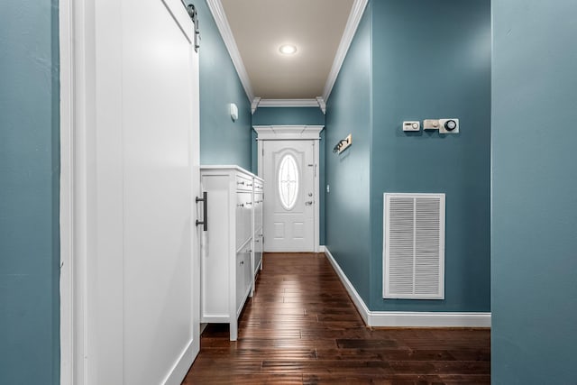 entryway featuring a barn door, ornamental molding, and dark hardwood / wood-style flooring