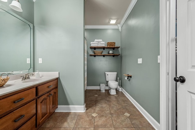 bathroom with tile patterned flooring, ornamental molding, vanity, and toilet