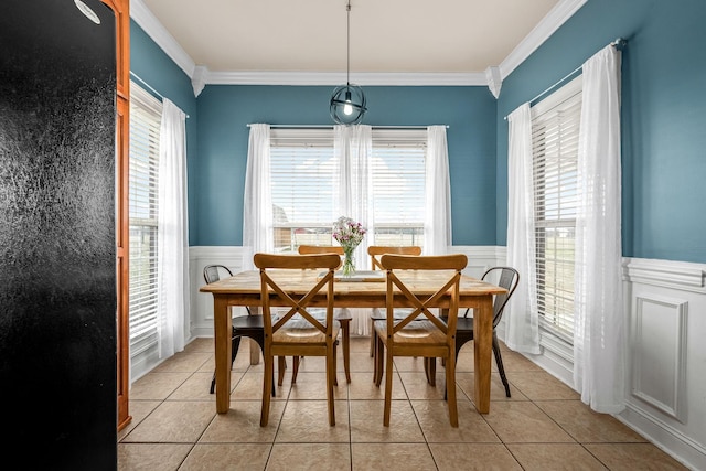 tiled dining room featuring ornamental molding