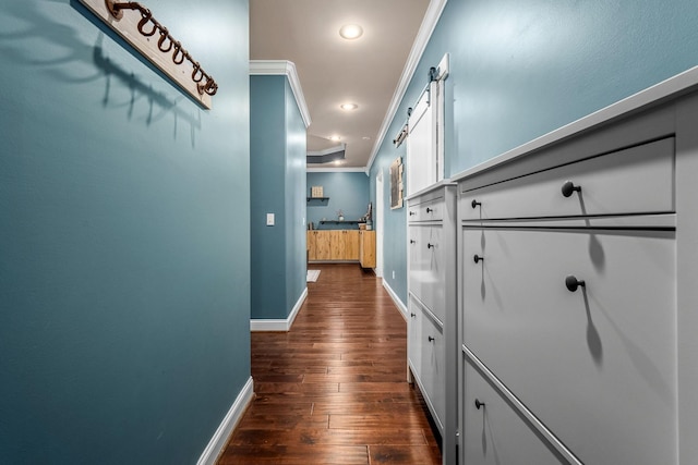 hall with dark wood-type flooring and ornamental molding