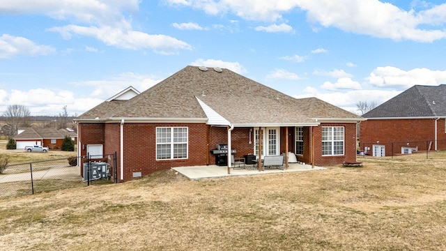 rear view of house featuring a patio and a yard